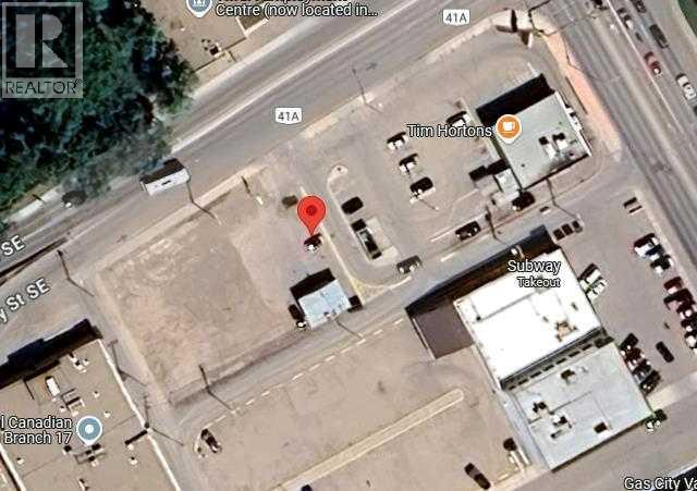 A satellite image shows a street view with a red marker indicating a specific location.