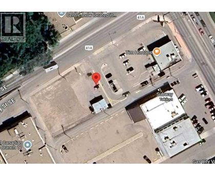 A satellite image shows a street view with a red marker indicating a specific location.
