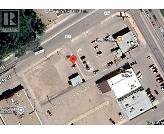 A satellite image shows a street view with a red marker indicating a specific location.