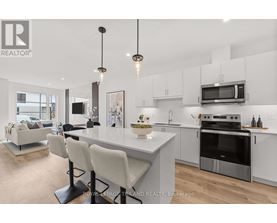A modern kitchen with white cabinets and a large island.