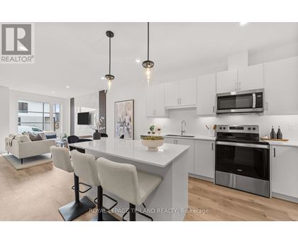 A modern kitchen with white cabinets and a large island.