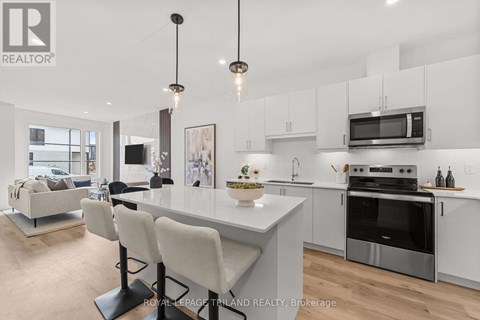 A modern kitchen with white cabinets and a large island.
