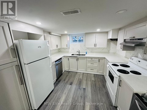 A kitchen with white appliances and wooden floors.