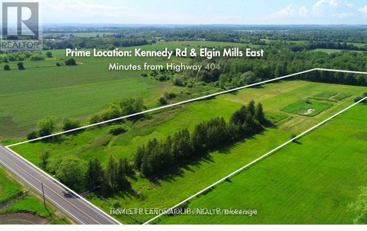 An aerial view of a green field with a road running through it and text indicating the prime location and distance from Highway 404.