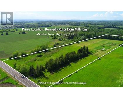 An aerial view of a green field with a road running through it and text indicating the prime location and distance from Highway 404.