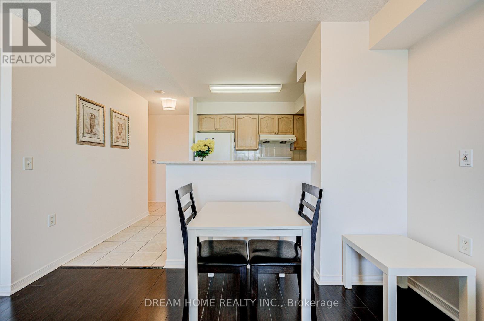 A dining room with a table and chairs.