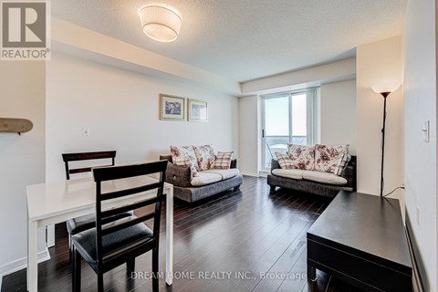 A living room with a white table and two chairs.