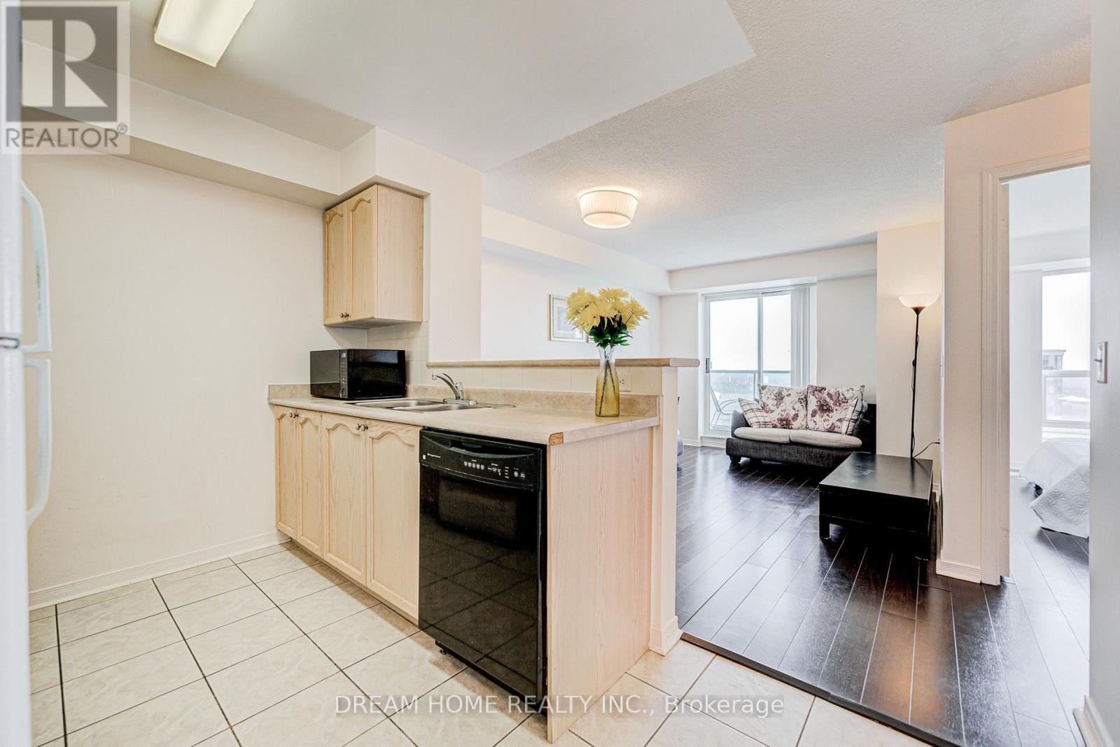 A kitchen with a black oven and a wooden counter.