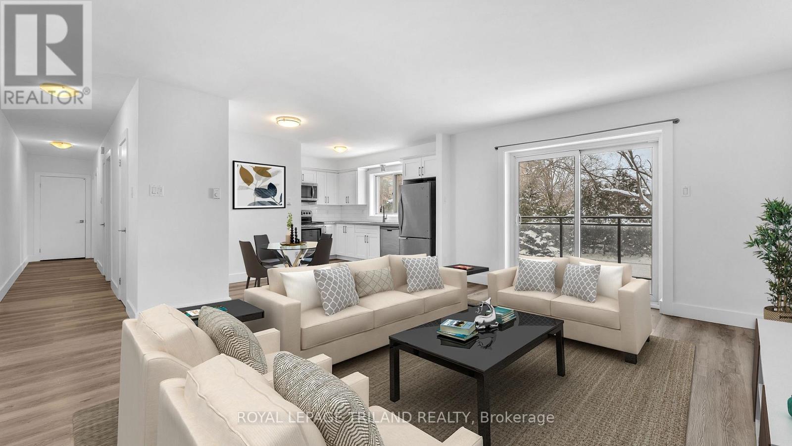 A living room with a couch, a coffee table, and a television.