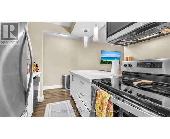 A modern kitchen with a stainless steel refrigerator and a stove top oven.