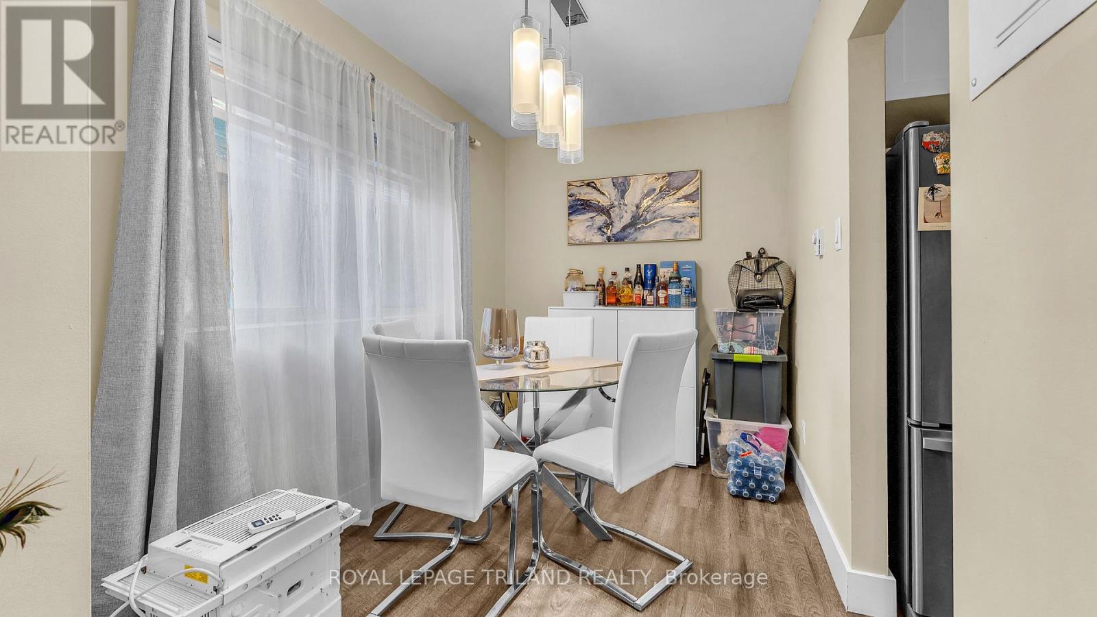 A dining area with a table and chairs.