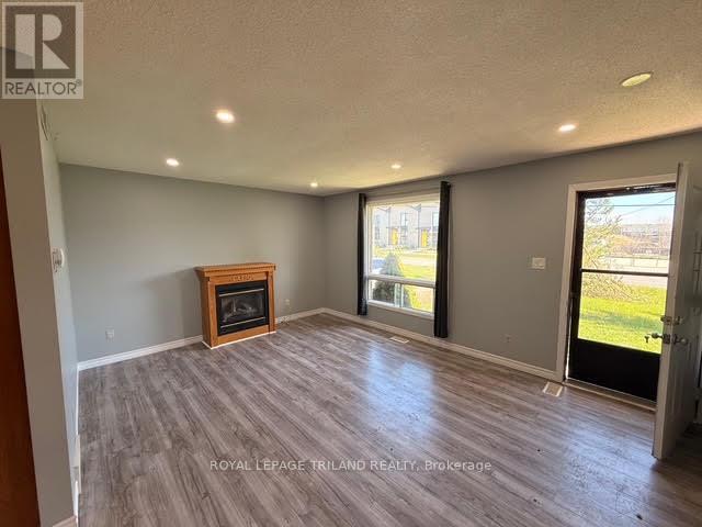 A spacious room with a fireplace and sliding glass doors.
