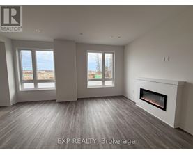 A spacious room with a fireplace and large windows.