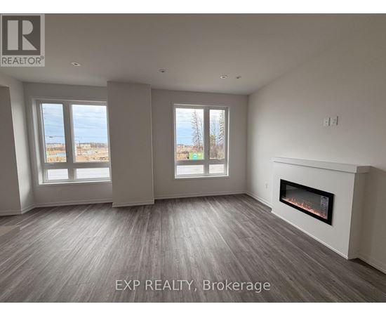 A spacious room with a fireplace and large windows.
