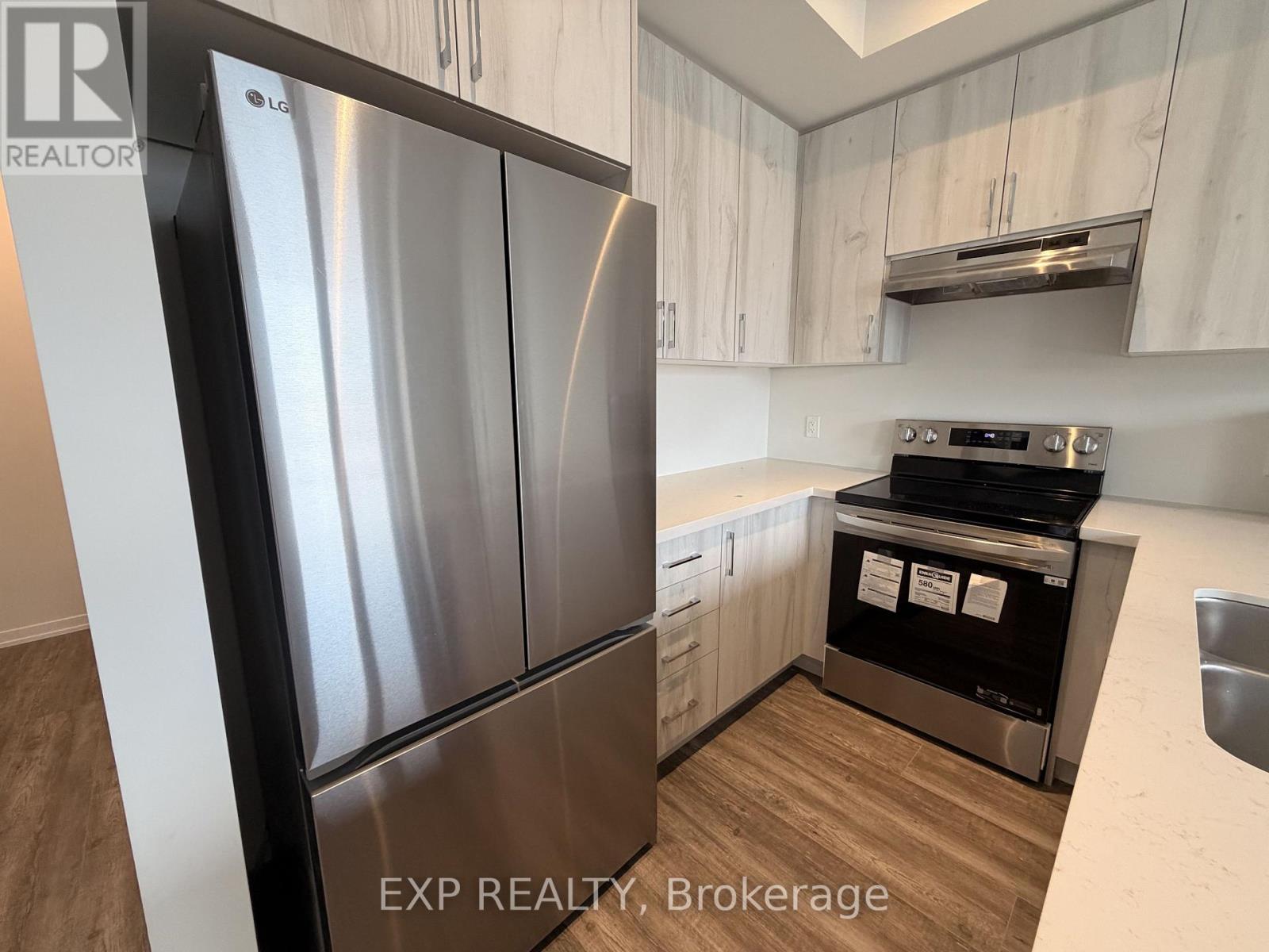 A kitchen with a stainless steel refrigerator and stove.