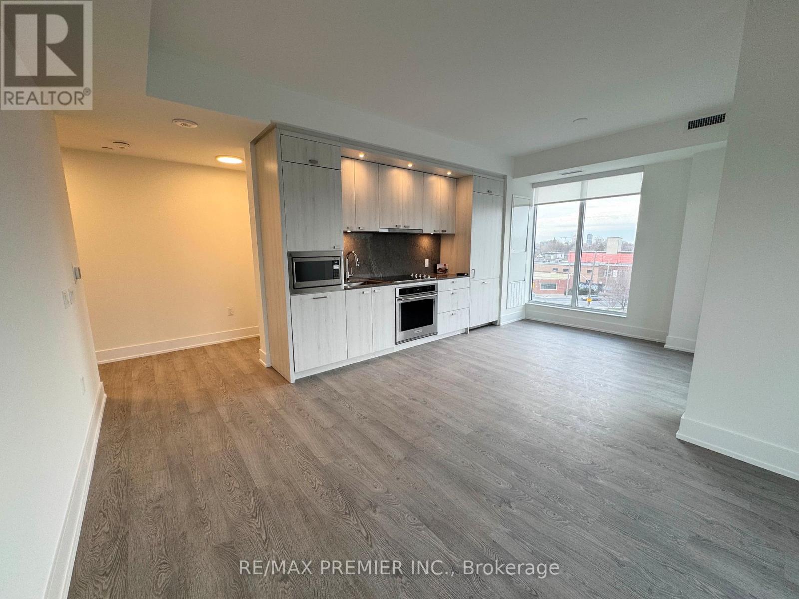 A spacious kitchen with white cabinets and a microwave above the stove.