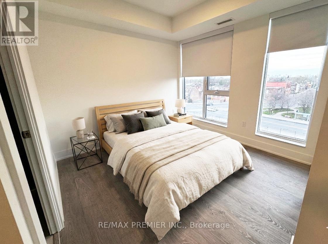 A bedroom with a large bed and a view of the city.