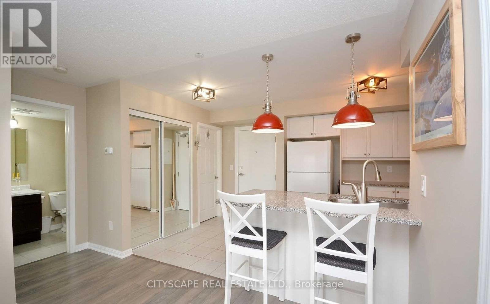A kitchen with a dining table and chairs.