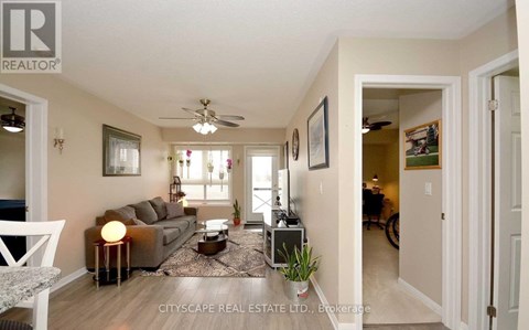 A well-lit living room with a grey sofa and a coffee table.