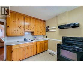 A kitchen with wooden cabinets and a black stove top oven.