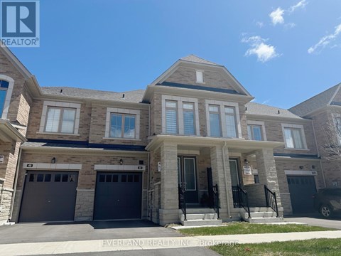 A large, two-story house with a garage is for sale.