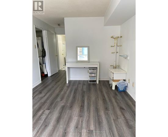 A room with a desk and a chair in it.