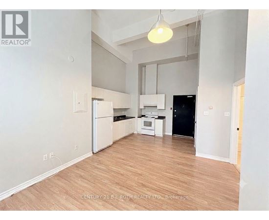 A kitchen with white appliances and wooden floors.