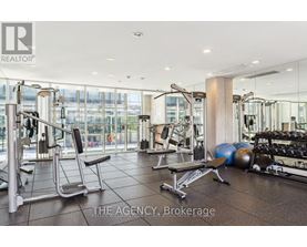 A gym with a variety of equipment including weights and a bench press.