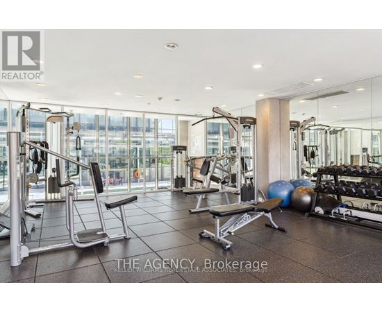 A gym with a variety of equipment including weights and a bench press.
