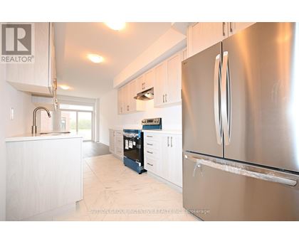 A modern kitchen with a stainless steel refrigerator.