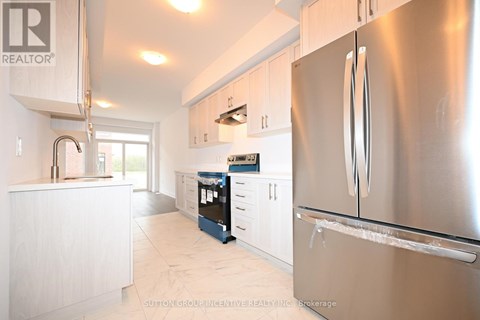 A modern kitchen with a stainless steel refrigerator.