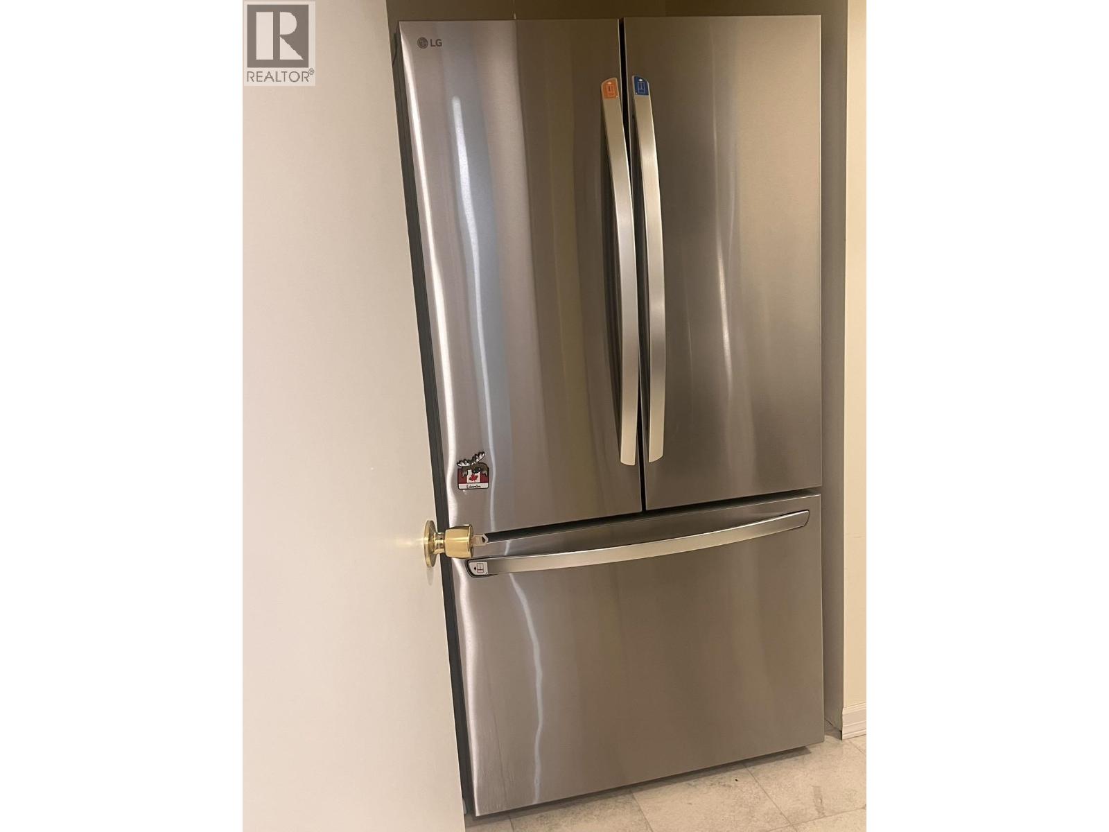 A stainless steel refrigerator with a water and ice dispenser on the door.