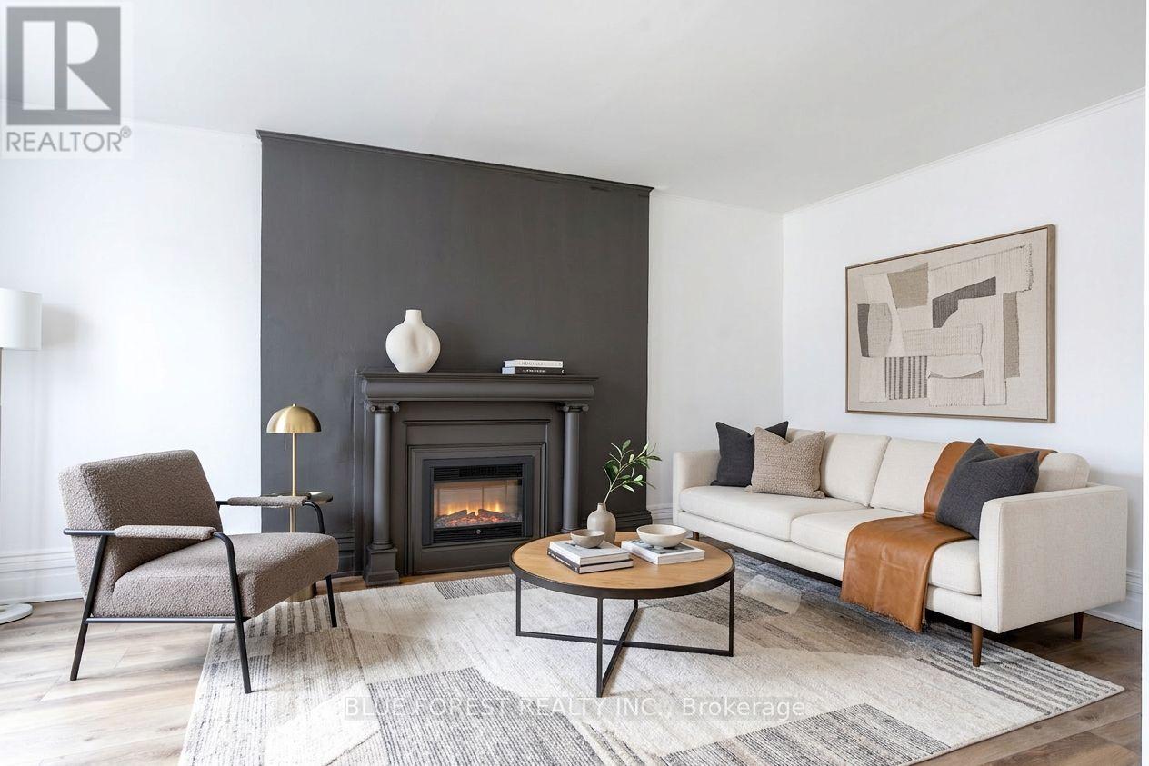 A living room with a fireplace and a grey sofa.
