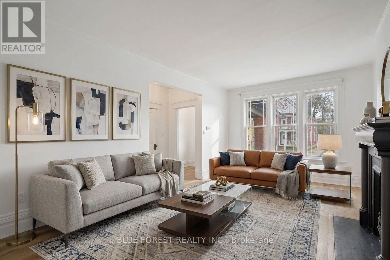 A living room with a grey couch, a coffee table, and a fireplace.