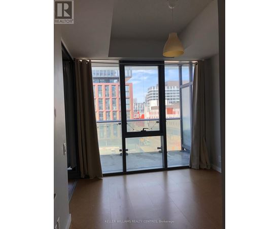 A room with a sliding glass door leading to a balcony.