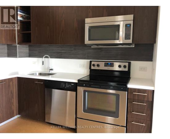 A modern kitchen with a stainless steel dishwasher and oven.