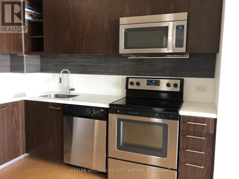 A modern kitchen with a stainless steel dishwasher and oven.