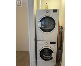A white washing machine is in a small room.