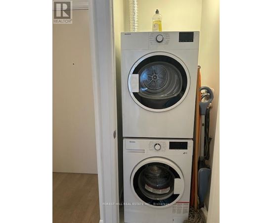 A white washing machine is in a small room.