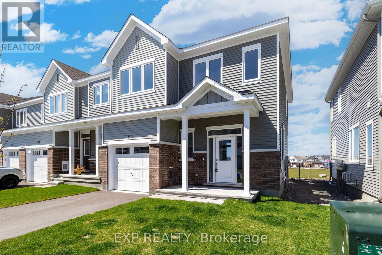 A house with the text EXP REALTY, Brokerage on the front yard.