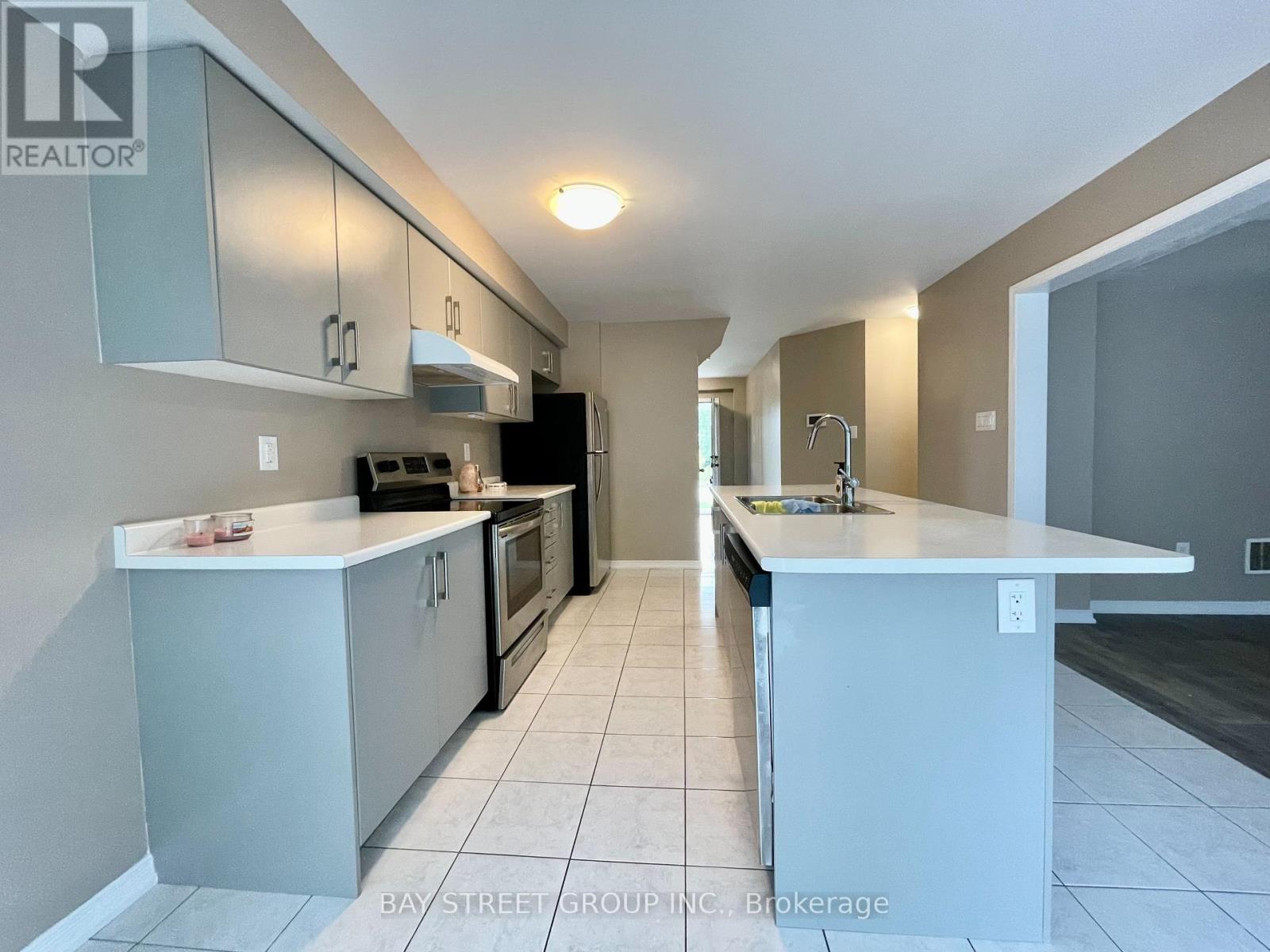 A kitchen with white cabinets and a white counter top.
