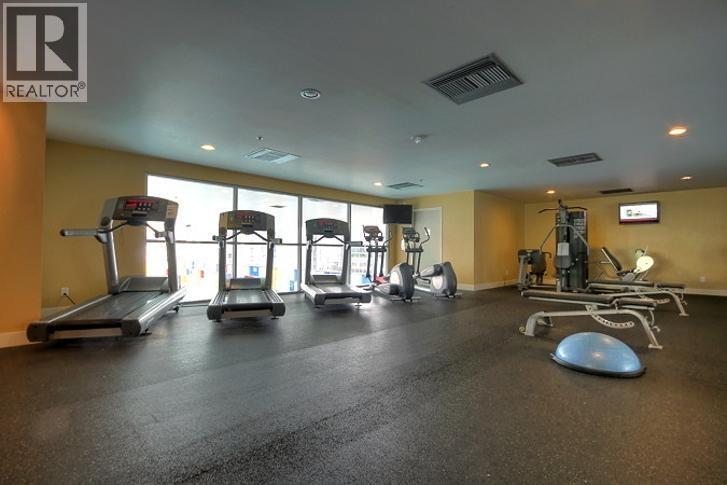 A gym with treadmills, elliptical machines, and other exercise equipment.
