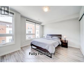 A bedroom with a large bed and a window overlooking a cityscape.