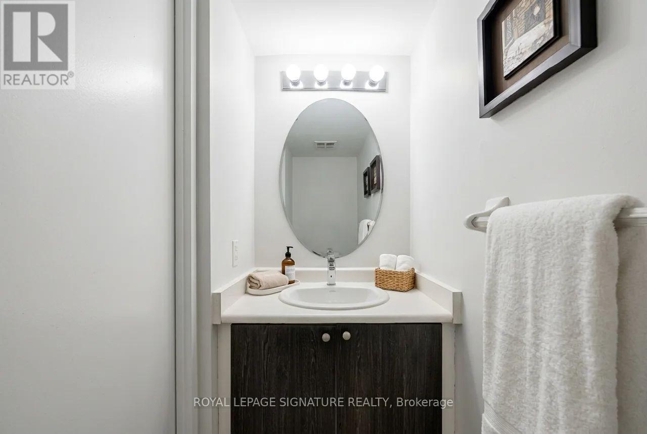 A white bathroom with a sink and mirror.
