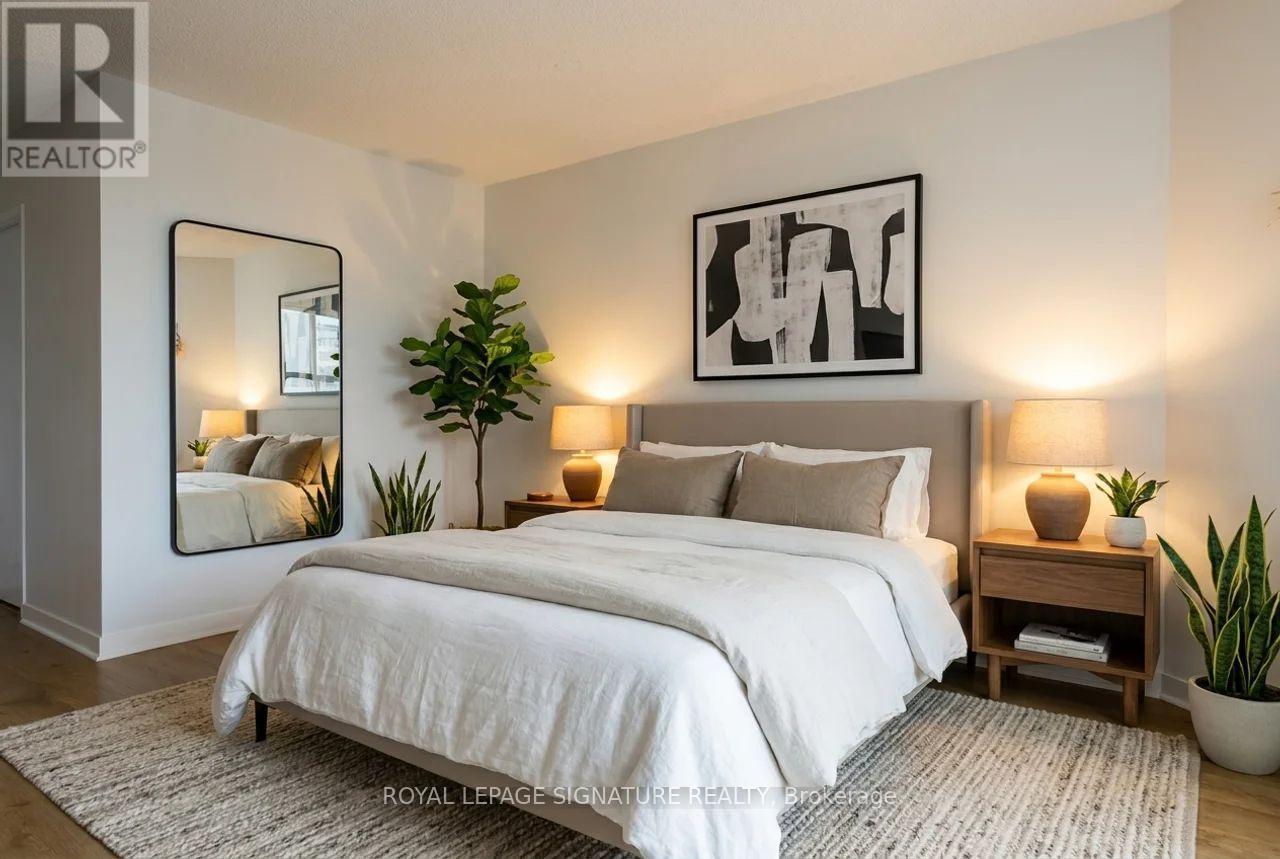 A bedroom with a large bed, a mirror, and a plant.