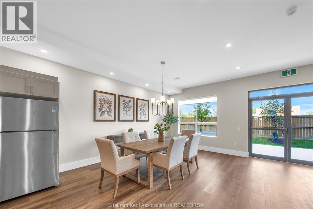 A dining room with a table set for six.