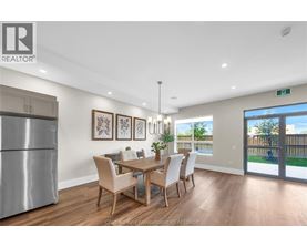 A dining room with a table set for six.