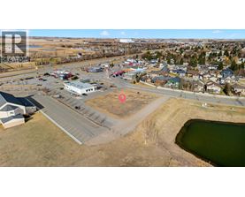 A small town with a lake and a parking lot.