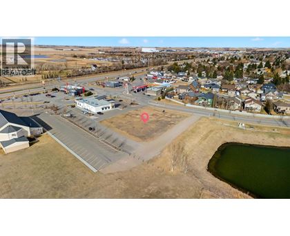 A small town with a lake and a parking lot.