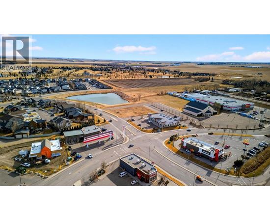 A small town with a large open field in the middle of it.